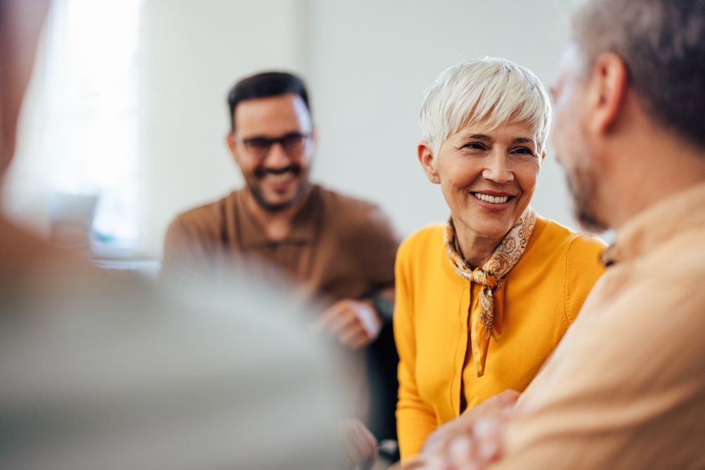 older woman smiling with friends