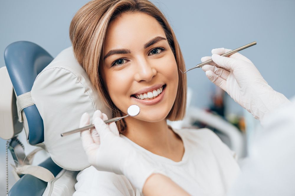 woman with short hair sit in dental office and look at camera