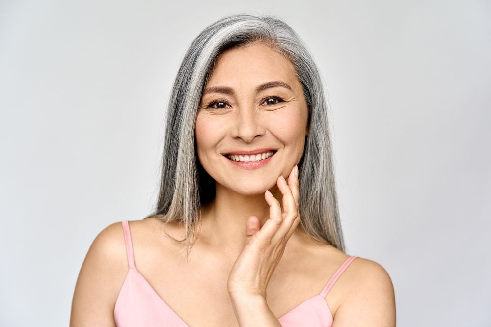 Headshot portrait of middle aged asian woman smiling