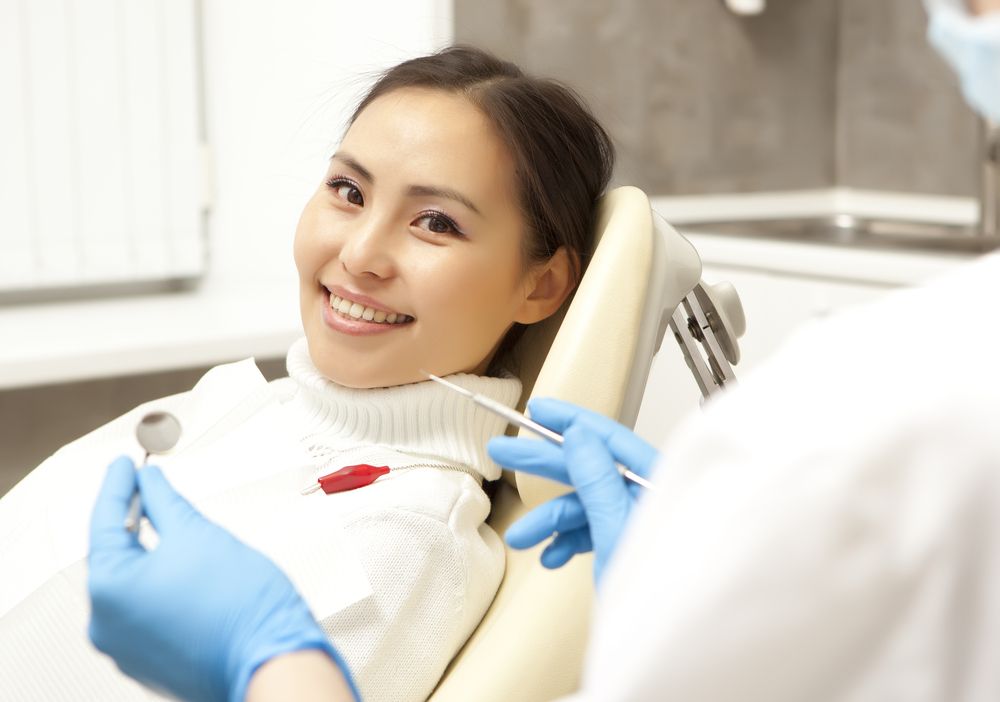 woman at the dentist, smiling for the camera