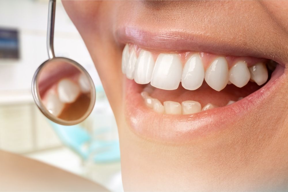 Smiling woman looking at her teeth