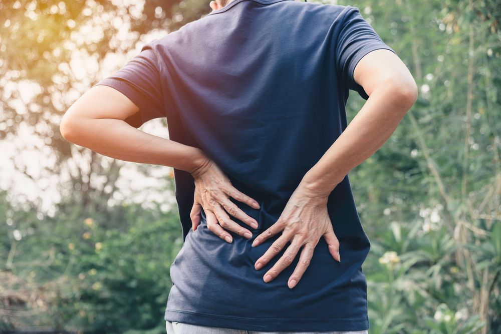 patient experiencing lower back pain and needs chiropractor treatment for relief