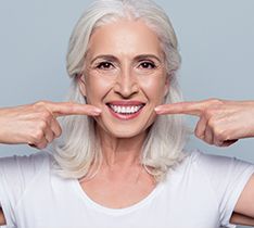 Woman pointing at her teeth