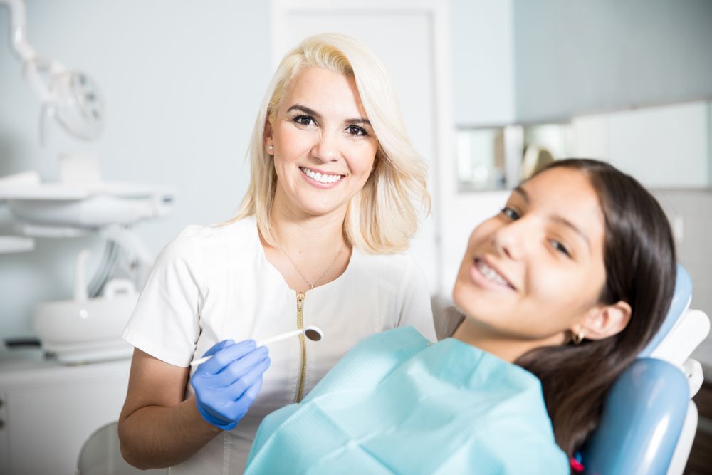 Girl patient with dentist​​​​​​​