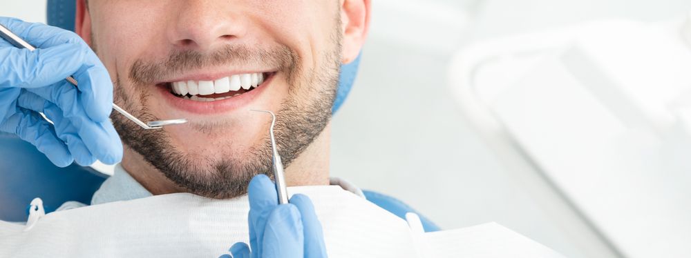 Young man at the dentist. Dental care, taking care of teeth​​​​​​​