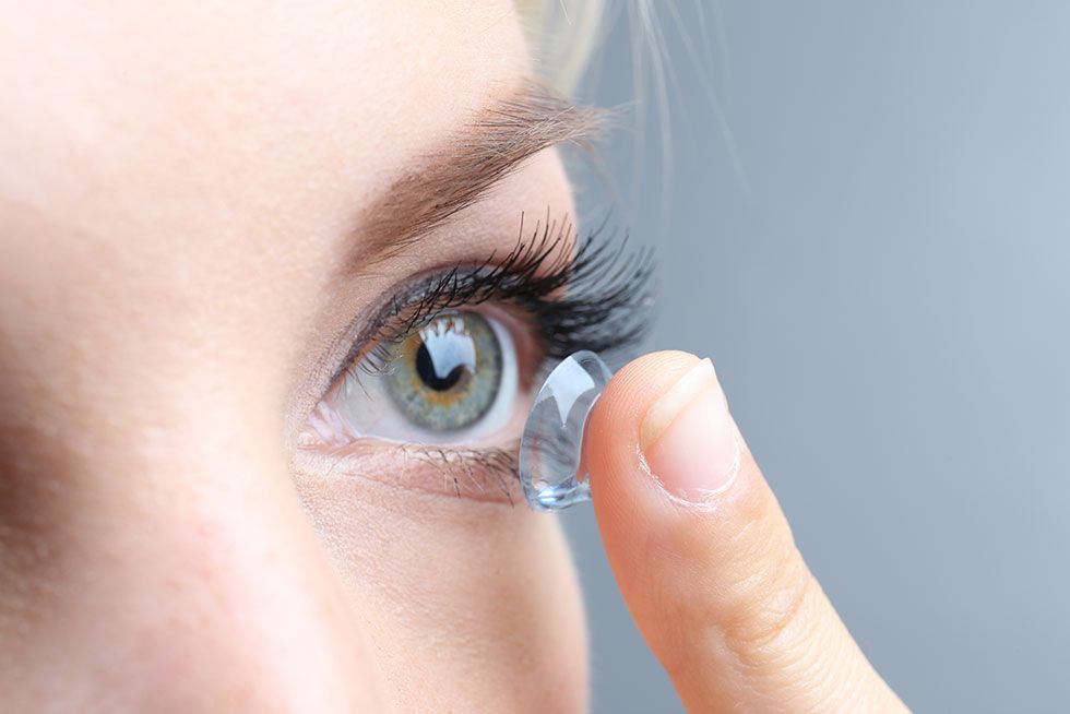 woman putting in contact lens