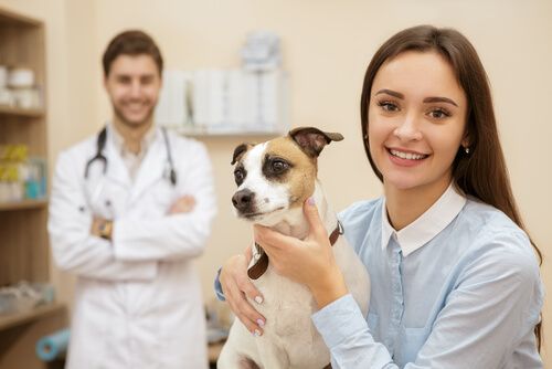 the dog and doctor taking a picture