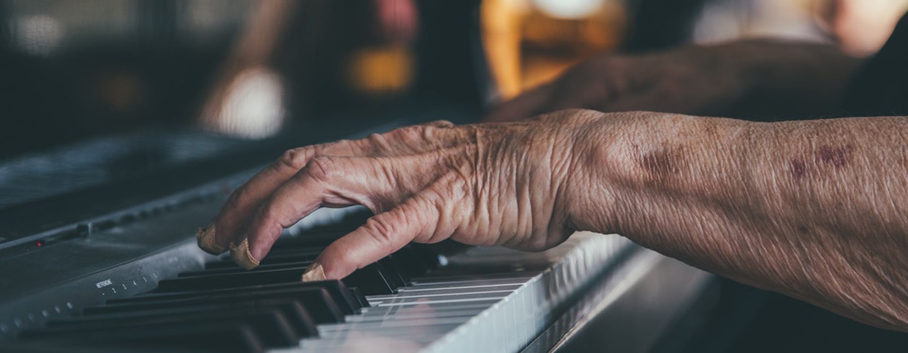 hands with bandages playing piano