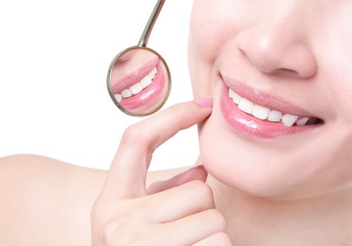 girl pointing at her teeth