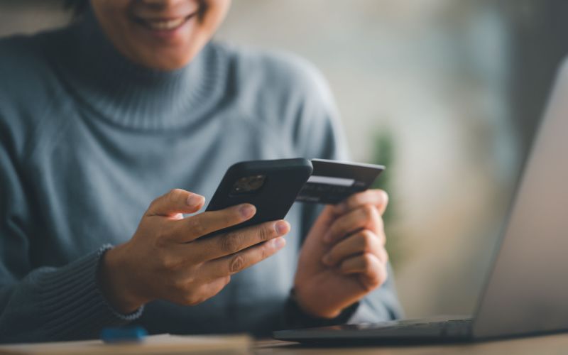 woman making online payment on her phone