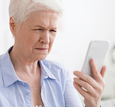 woman squinting at a phone