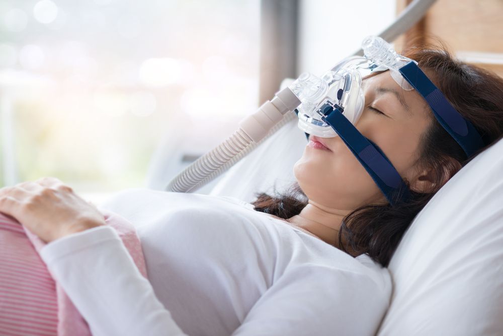 Resting woman with CPAP Machine
