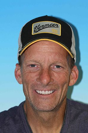 Man with a full set of dentures smiling for the camera