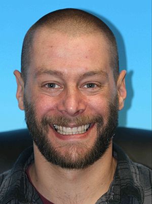 Man smiling after new dentures treatment