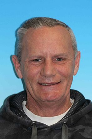 Man smiling with missing teeth and tooth discoloration