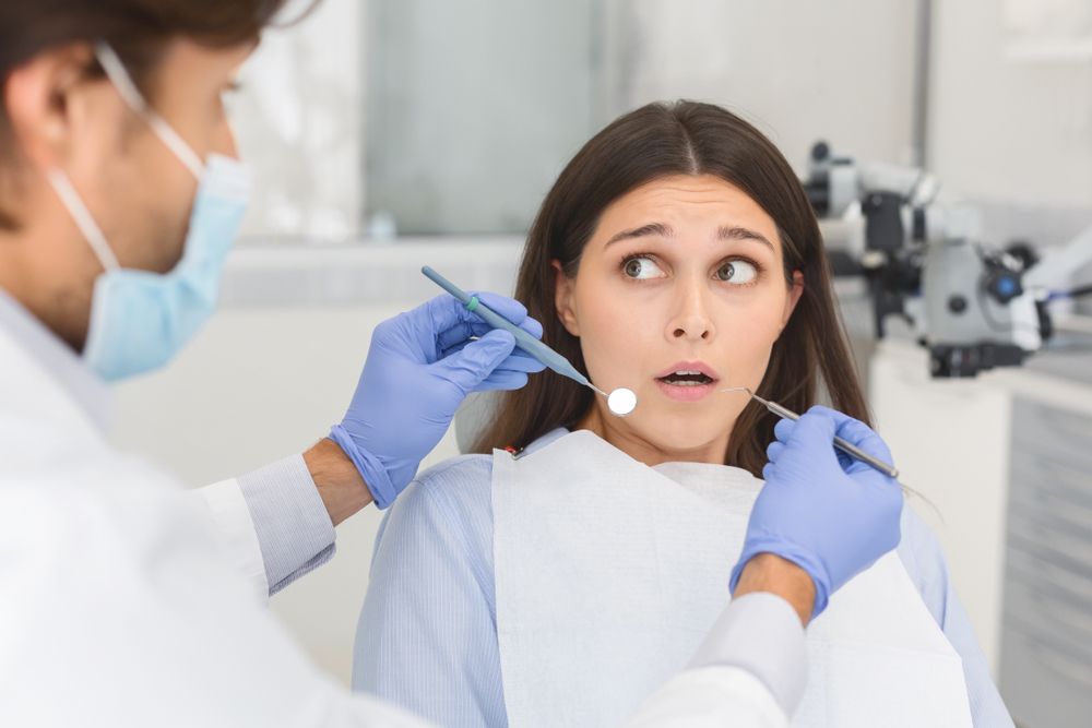 woman fearful of the dentist​​​​​​​