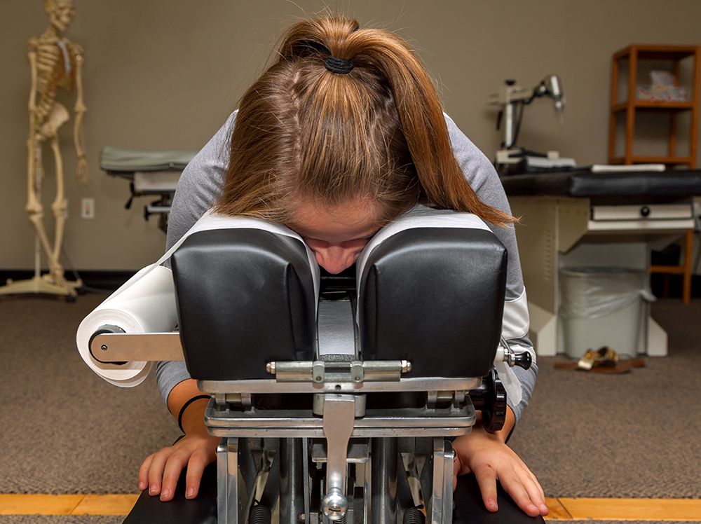 Woman sit on a chiropractic chair