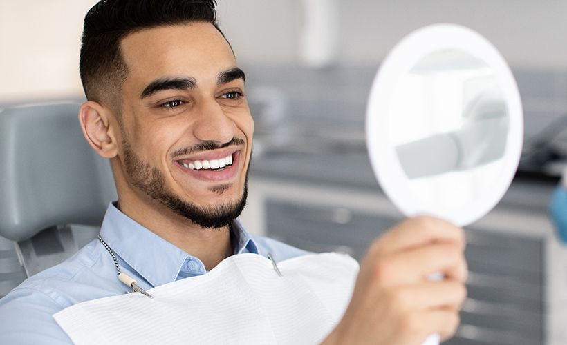 man smiling at his reflection