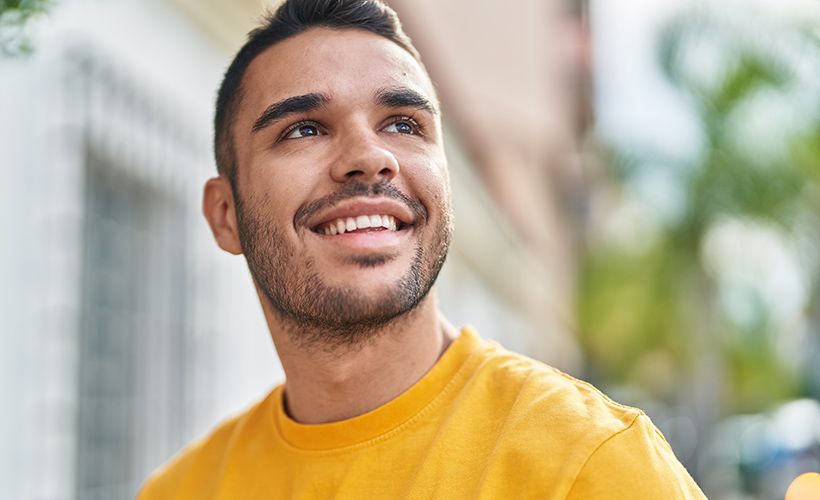 man smiling toward the sky