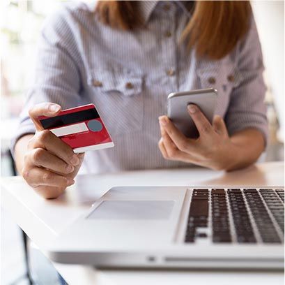 woman holding a phone and a card