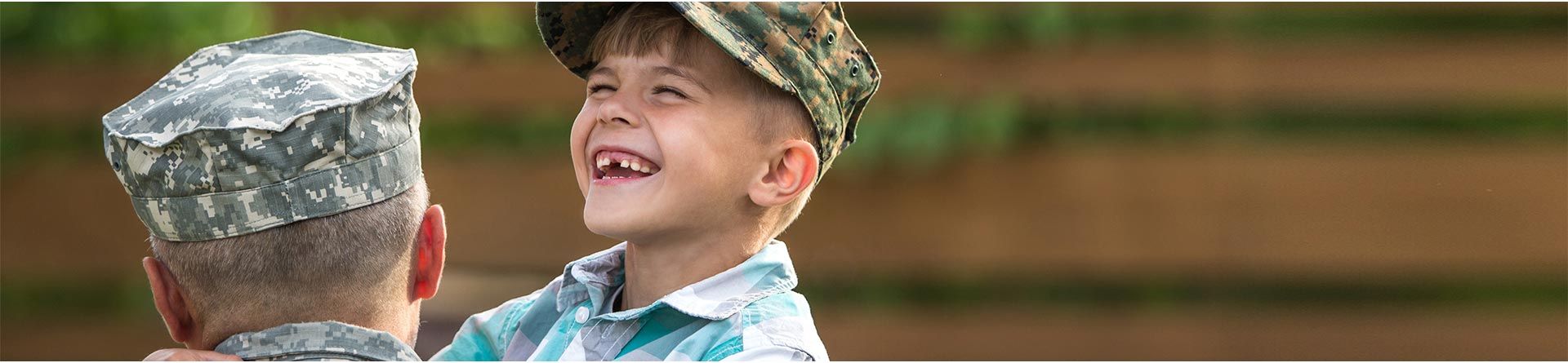 happy kid carried by a military man