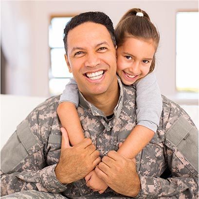 child hugging her military dad