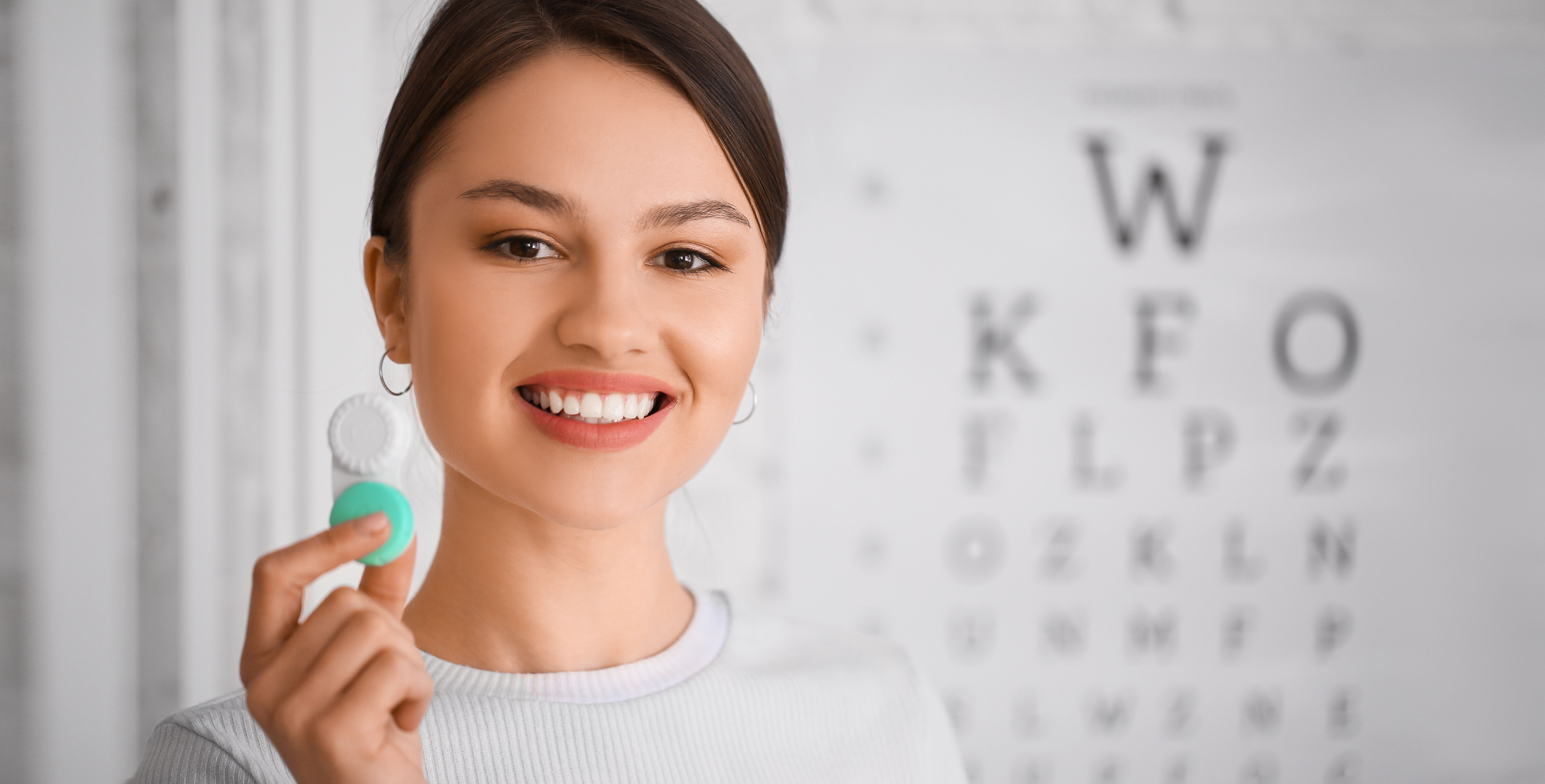 Young woman with contact lenses at ophthalmologist's office