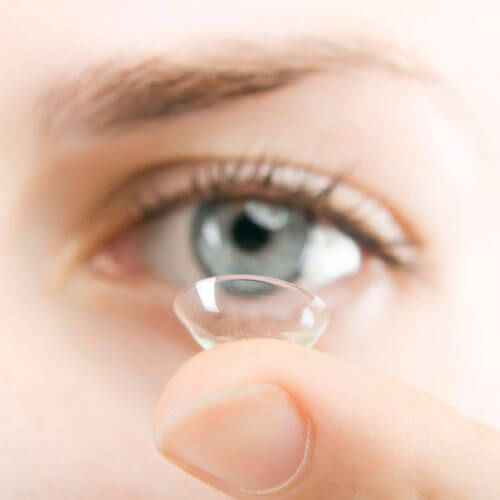 lady holding a contact lens