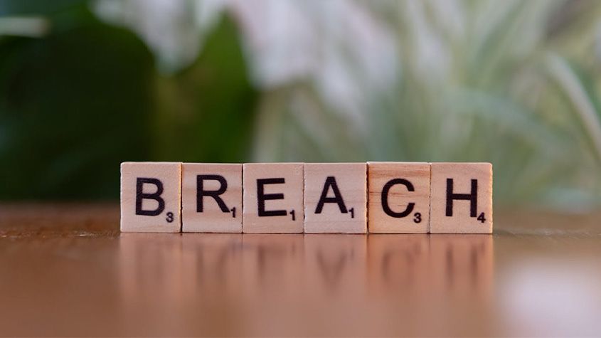 Wooden letter tiles spelling &ldquo;breach.&rdquo;