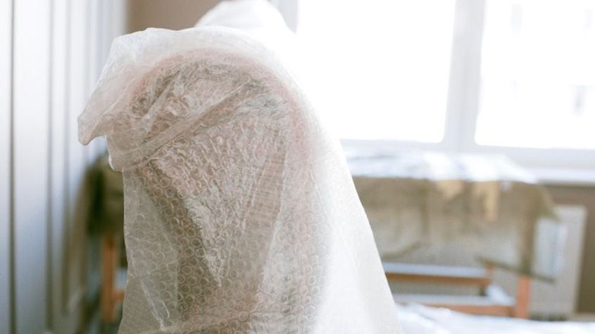 Chair wrapped for protection during home renovation.