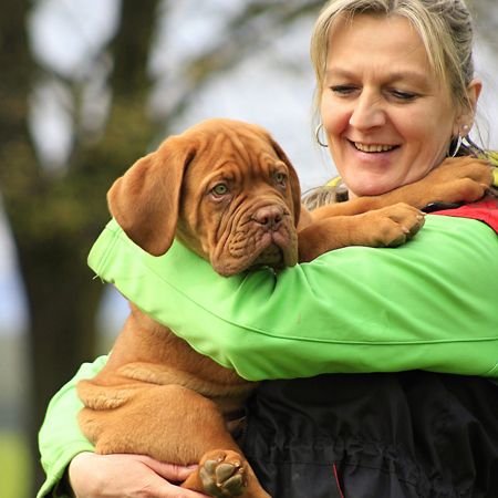 woman carrying a dog