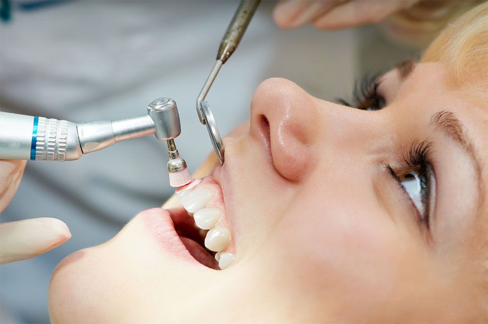 patient getting her teeth checked