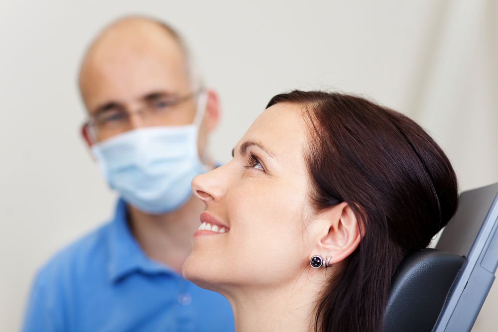 relaxed woman with dentist in clinic