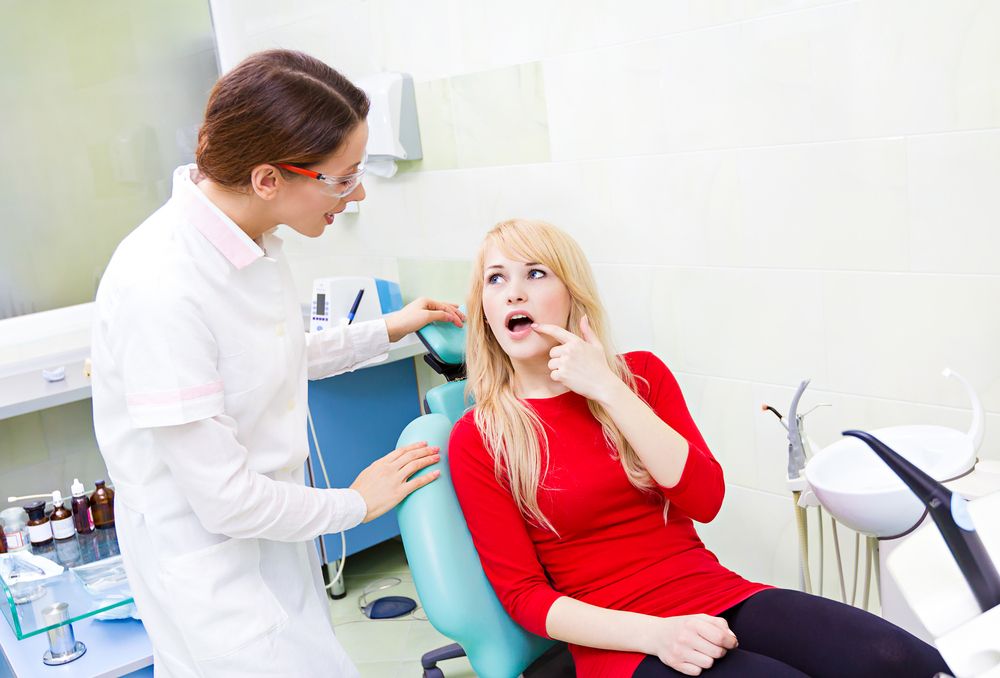 patient getting checked by dentist​​​​​​​