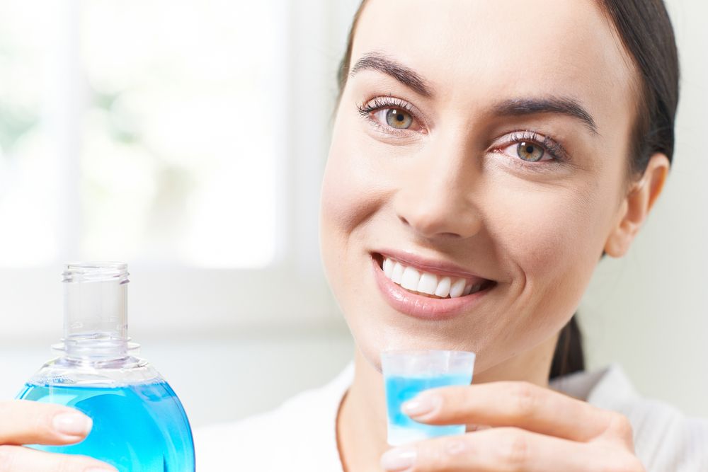 woman with mouthwash