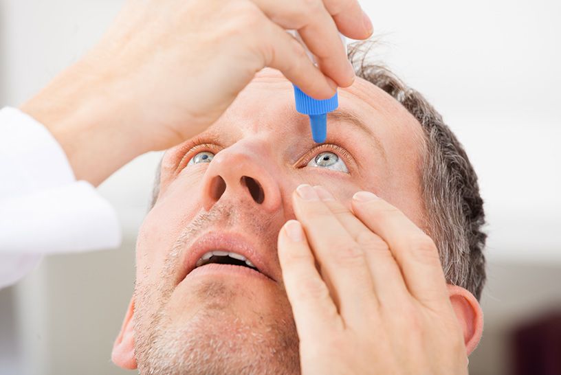 man putting in eye drops