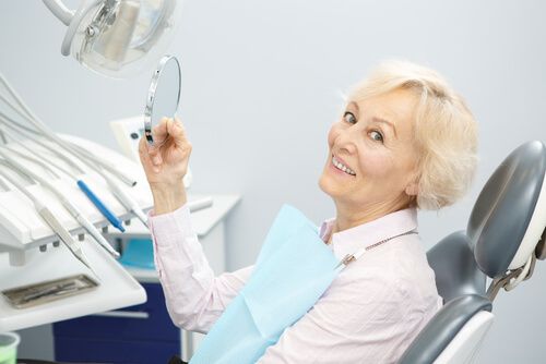 old smiling lady in a dental clinic