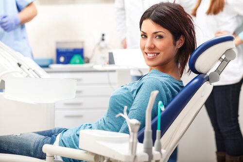 young female patient sitting on chair in dental office
