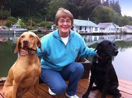 lady and two dogs on a boat