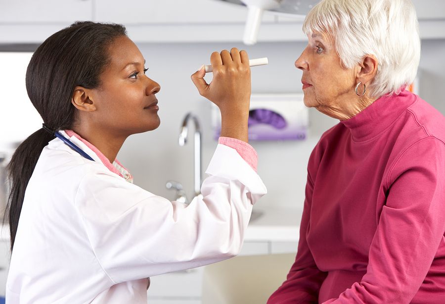 woman checking another womans eyes