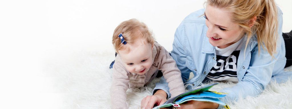 Young Mother Reading to baby