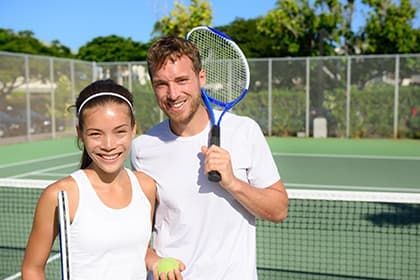 Young couple happy playing tennis