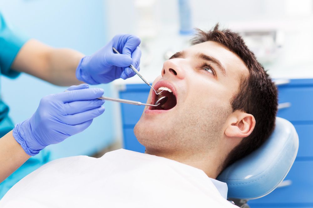 man at the dentist getting his wisdom teeth removed
