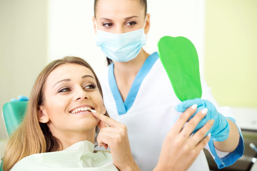 happy patient looking at her teeth