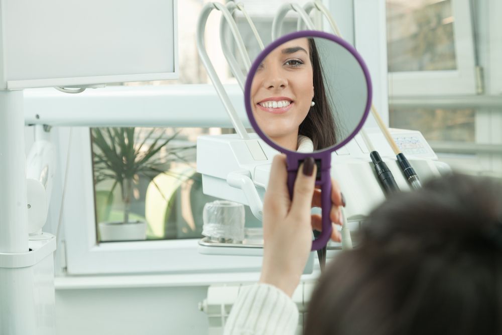 dental patient looking at the mirror after procedure