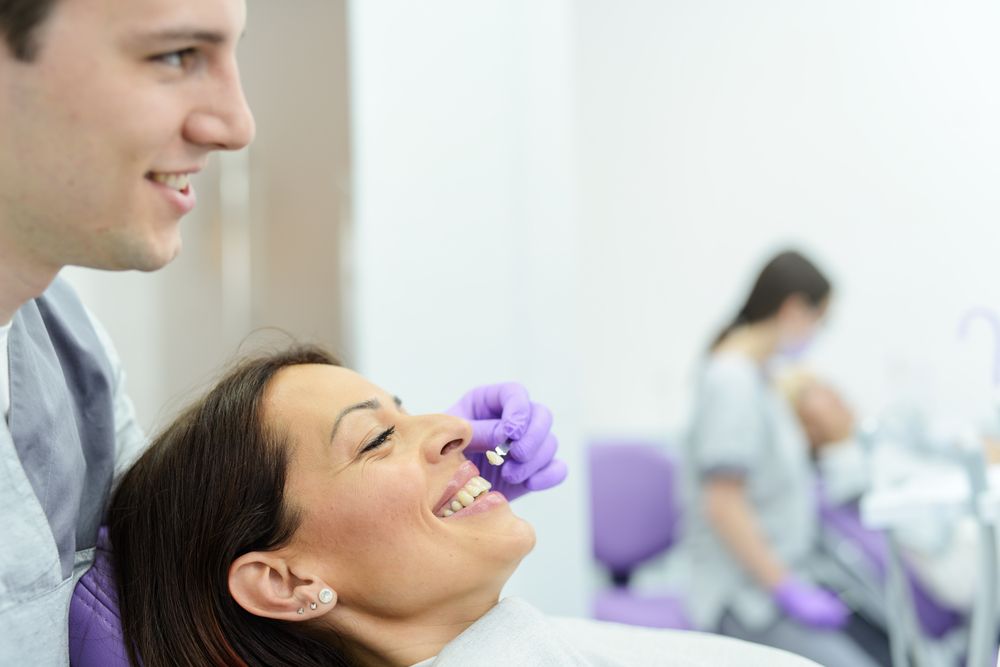 patient choosing veneer color with dentist