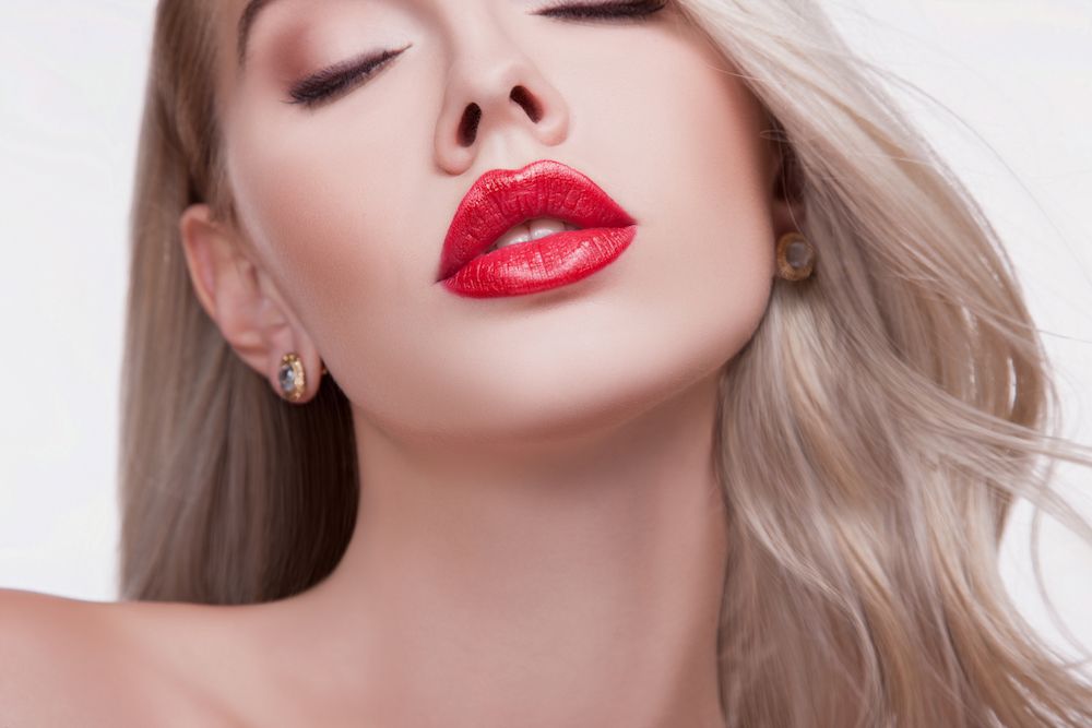 woman with big red lips and smooth skin
