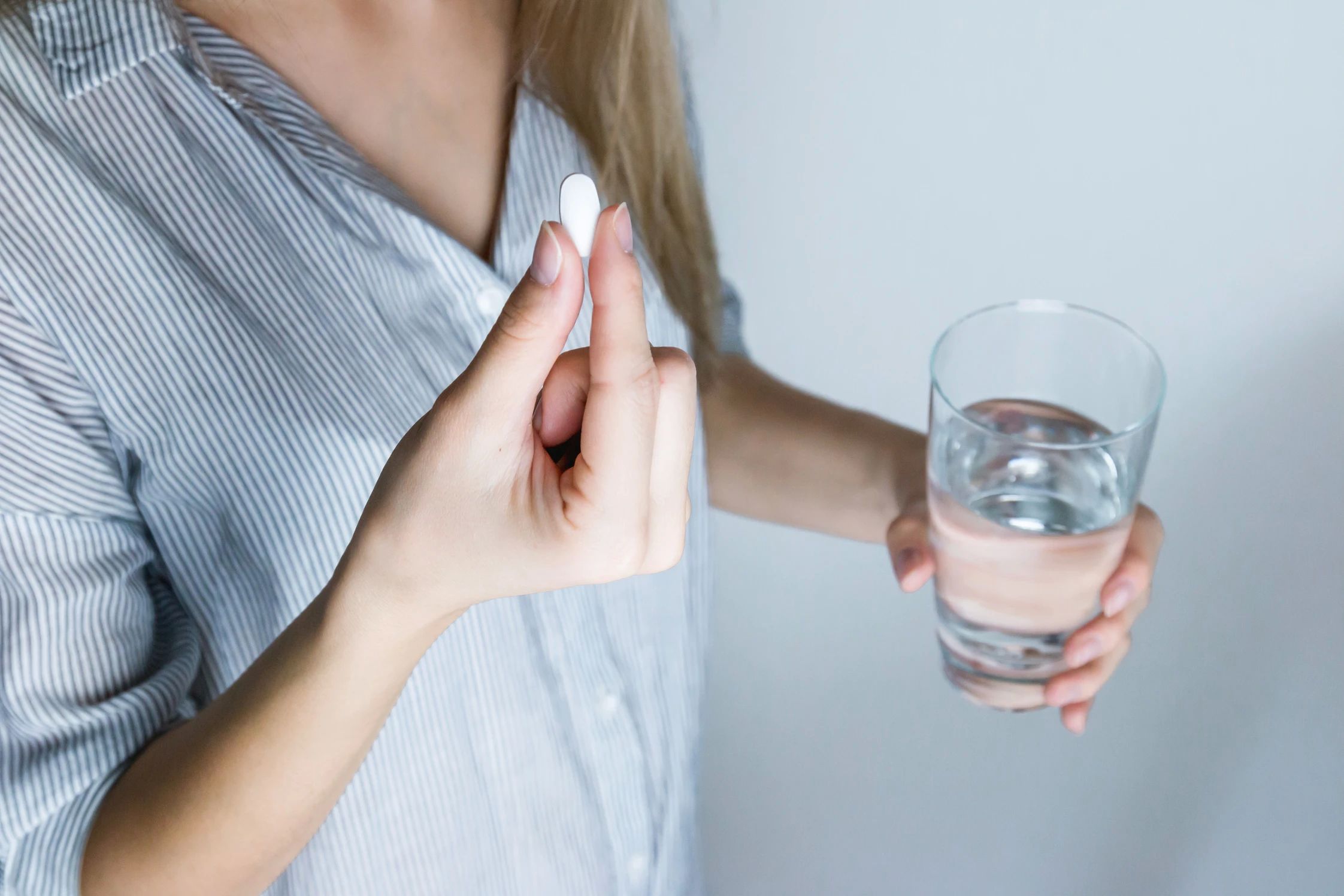 woman taking a pill