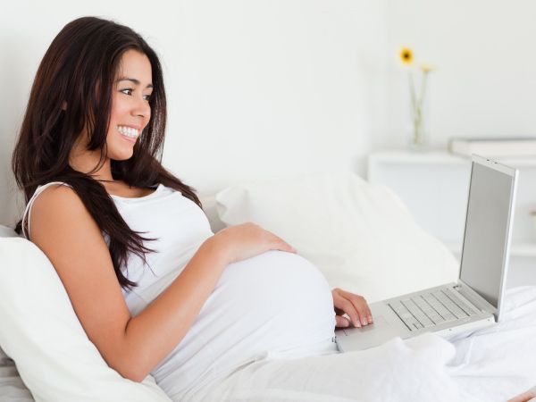 Pregnant using laptop
