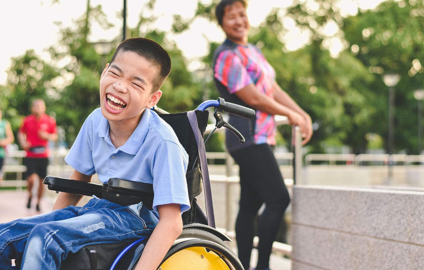 Disabled child on wheelchair is play and learn in the outdoor park